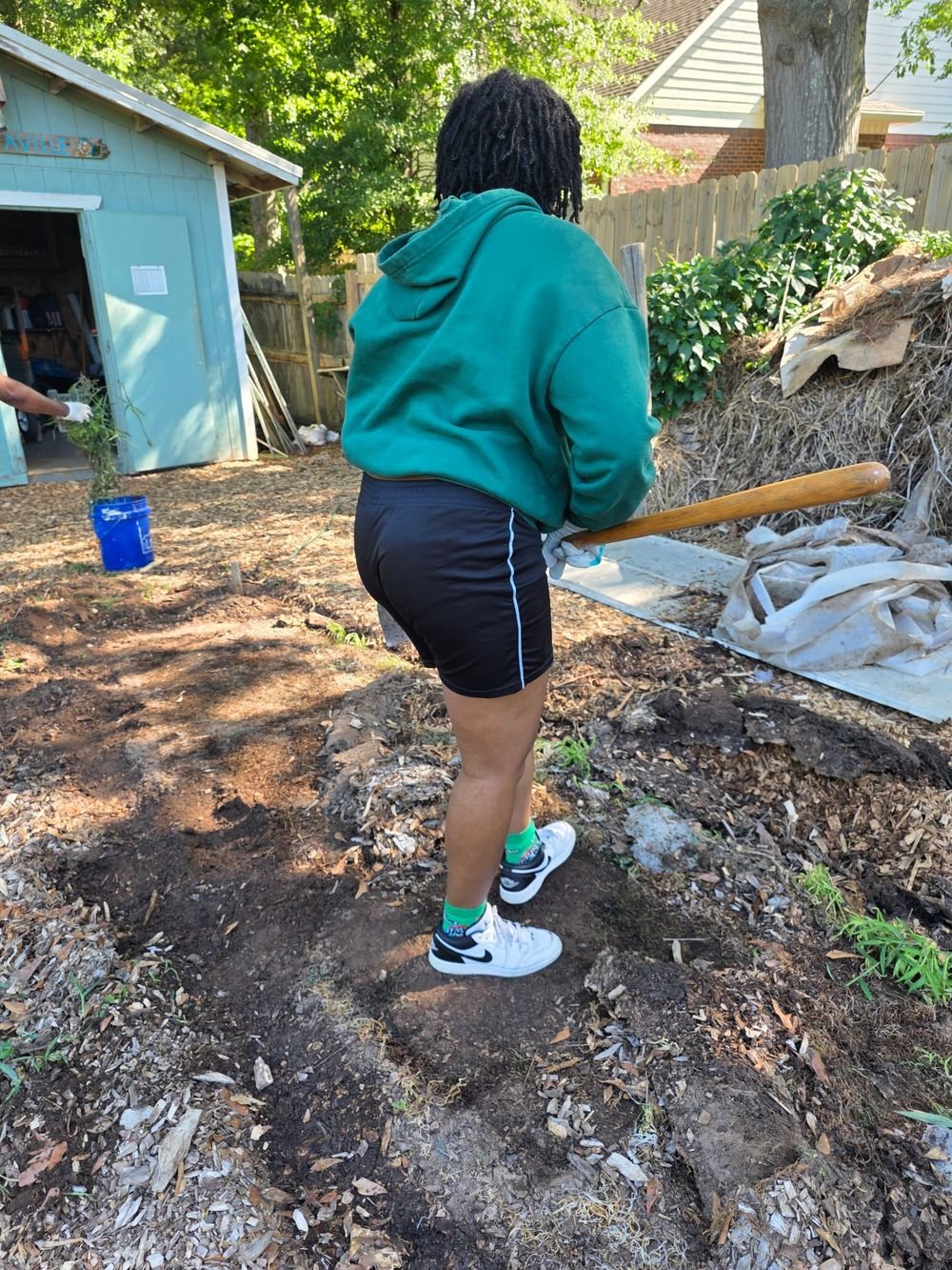 A volunteer working in the Allies Way community garden