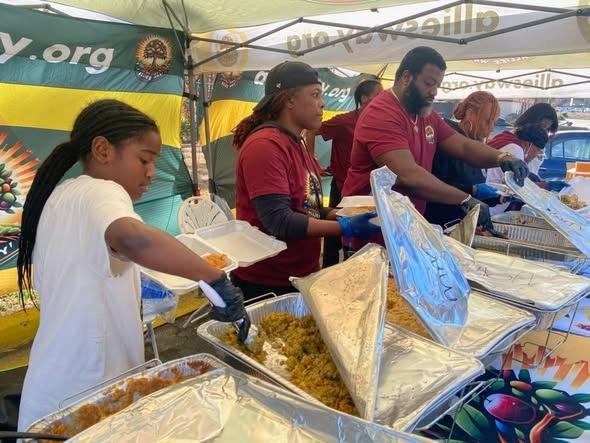Volunteers in Allies Way shirts serving hot food
